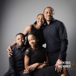 Family portrait of parents with two children dressed in black during a studio photography session at Moore & Moore Photography in Fleet, Hampshire.