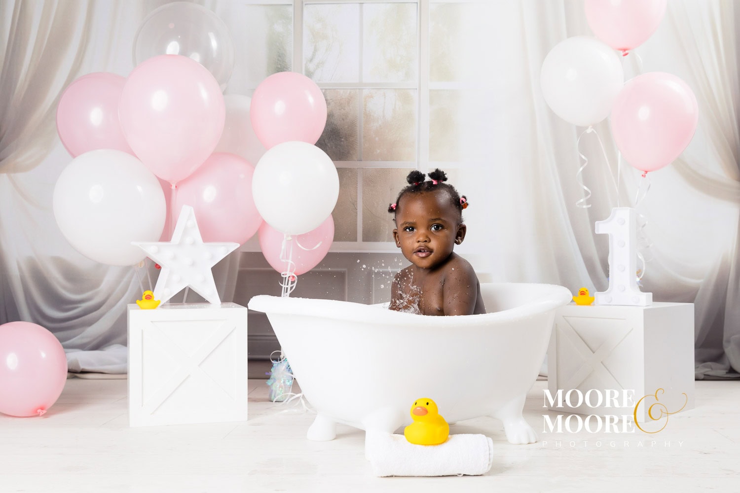 first-birthday-baby-milestone-portrait-joyful Happy one-year-old baby enjoying her first birthday milestone, relaxed and playful, reflecting a sense of safety, joy, and belonging built during her first year.